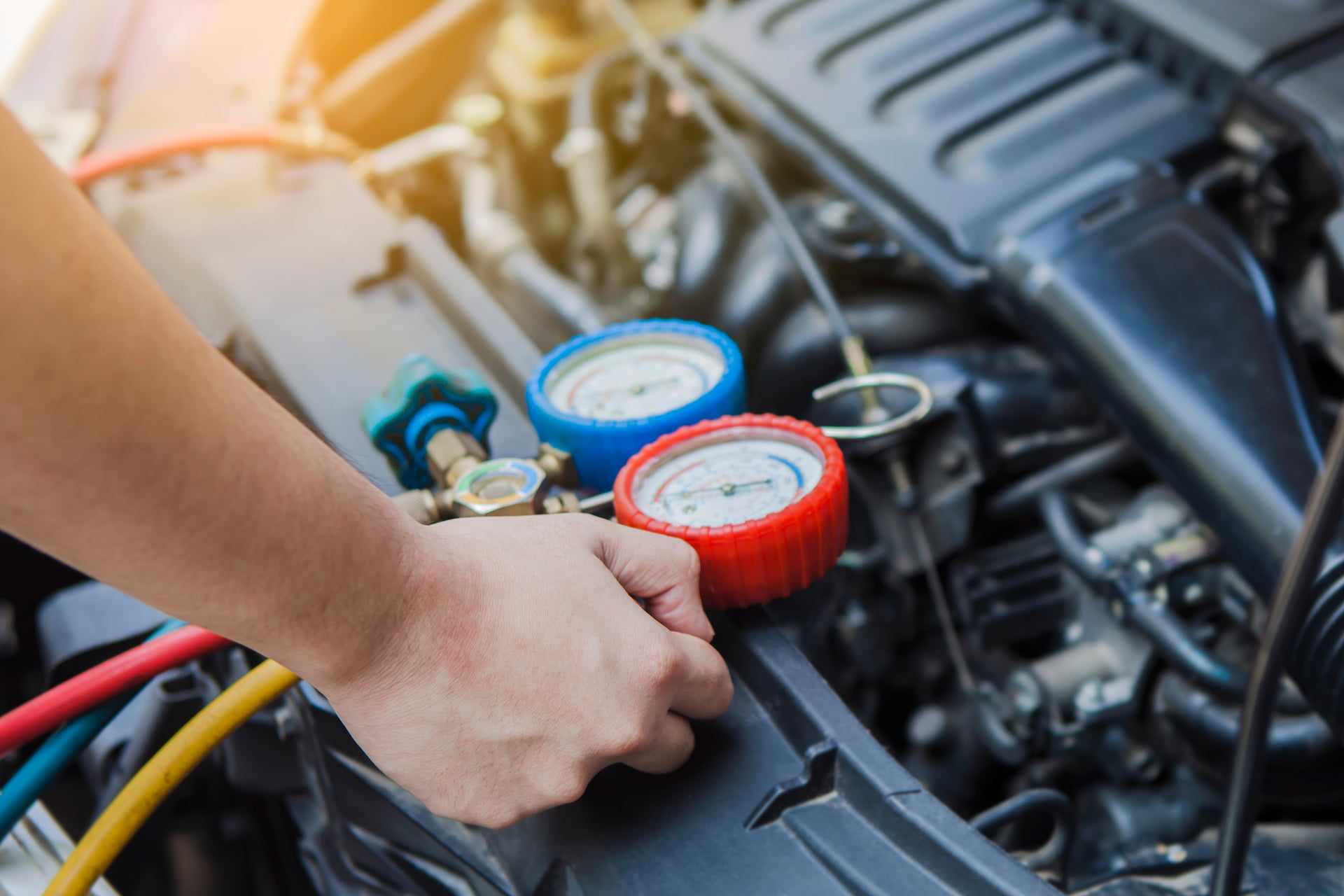 AC refrigerant gauge check during car AC repair in Fond du Lac Wi