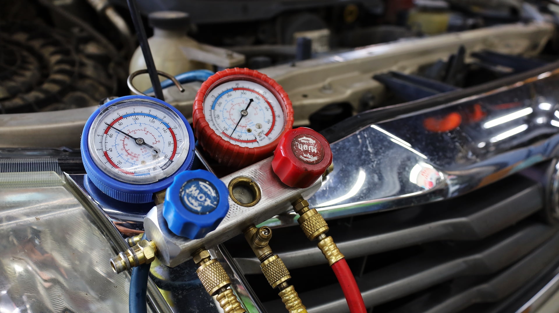 AC refrigerant gauge check during car AC repair in Menasha Wi