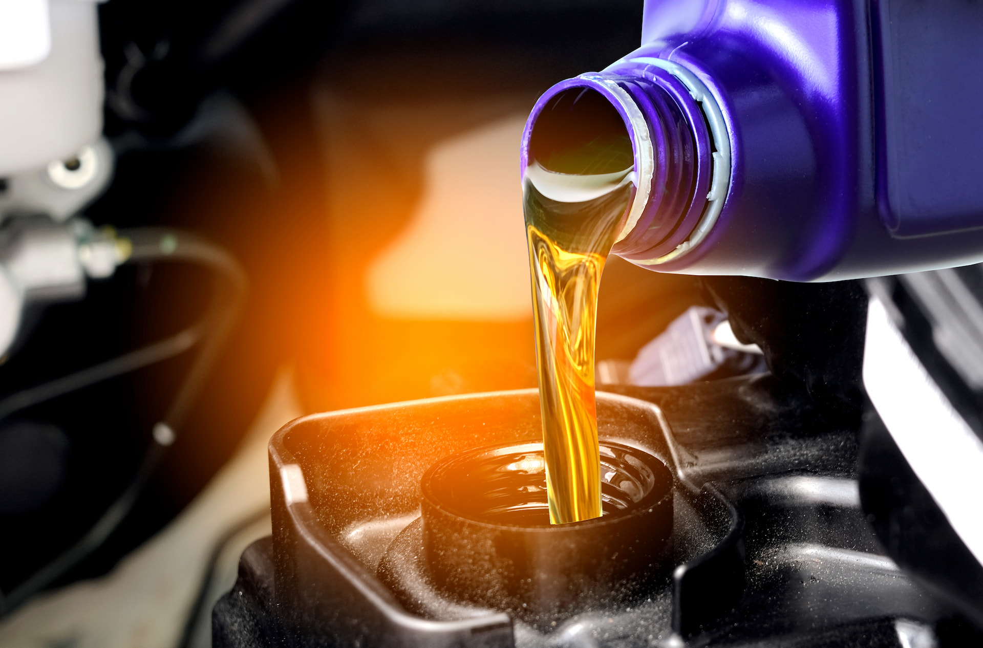 Oil being poured into engine during an oil change service