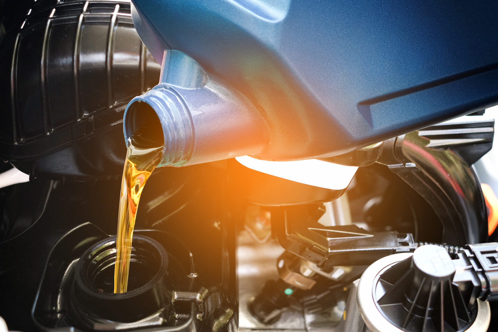 Oil being poured into engine during an oil change service