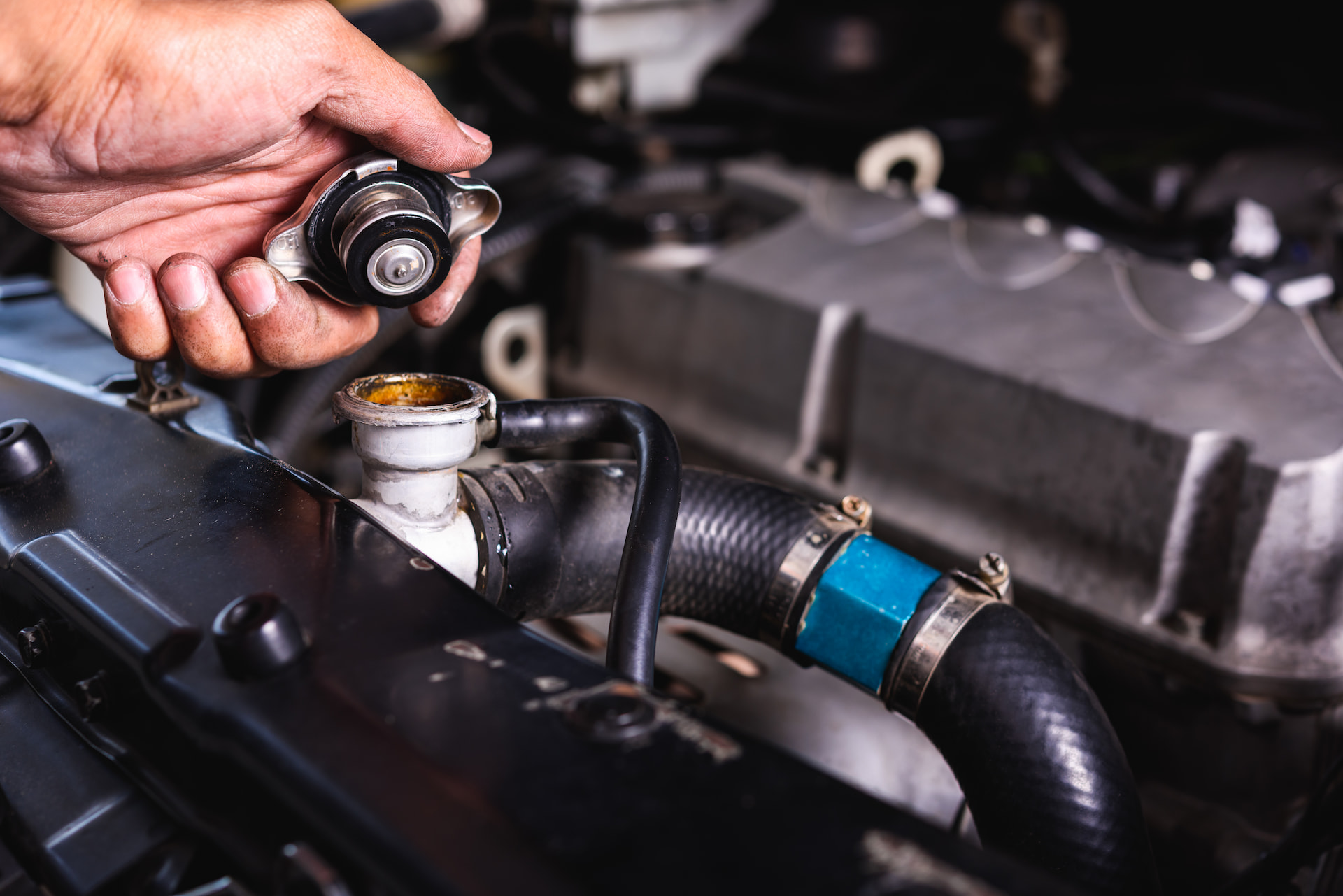 Radiator cap being removed during cooling system service