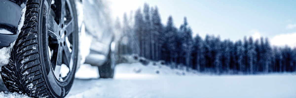 Truck driving down snow covered country road